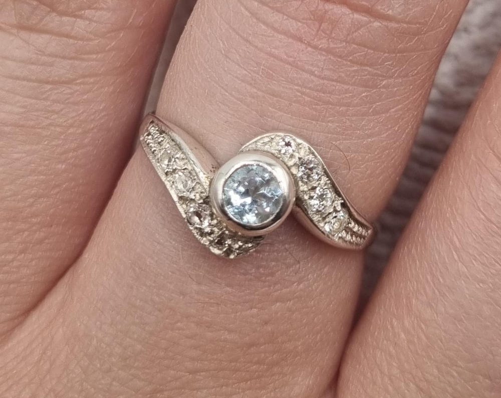 Curved ring with cubic zirconia and blue topaz in 925 Sterling silver